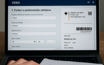 Ekran laptopa prikazuje otvoren Videx obrazac za njemačku vizu, uz pasoš i olovku na stolu